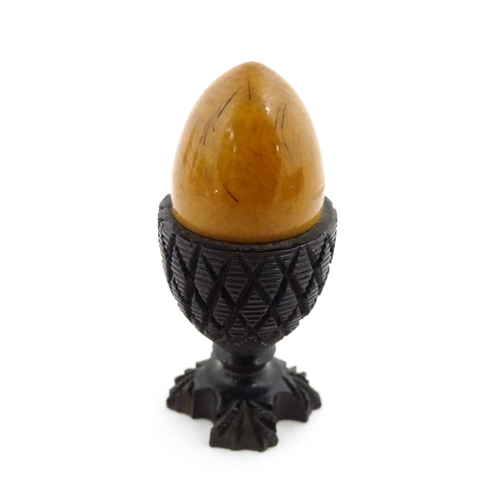 1152 - A 19thC treen / turned wooden thimble case and sewing thread holder of egg cup form, containing an e... 