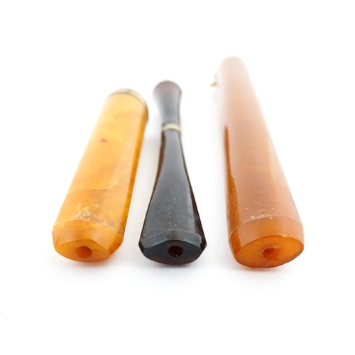 1171 - Three assorted early 20thC cheroot mouthpieces one with a Continental gold mount / ejector slide, an... 