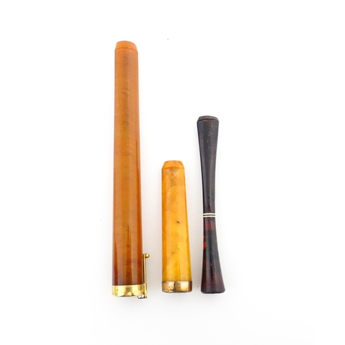 1171 - Three assorted early 20thC cheroot mouthpieces one with a Continental gold mount / ejector slide, an... 