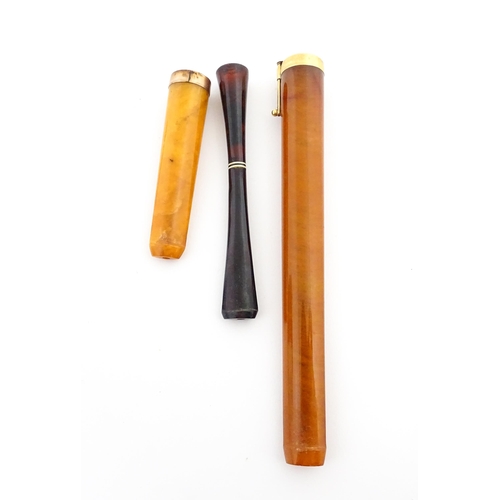 1171 - Three assorted early 20thC cheroot mouthpieces one with a Continental gold mount / ejector slide, an... 