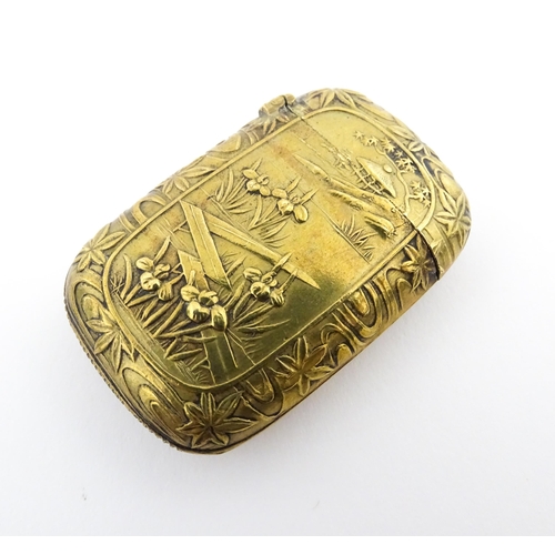 1173 - A 20thC brass vesta case with Oriental decoration. Approx. 1 3/4