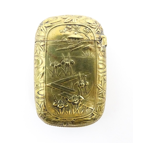 1173 - A 20thC brass vesta case with Oriental decoration. Approx. 1 3/4