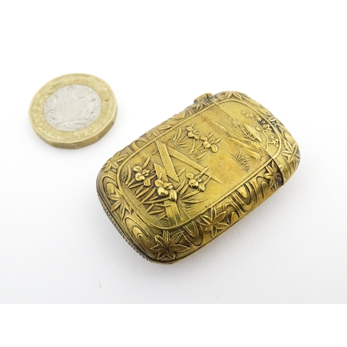 1173 - A 20thC brass vesta case with Oriental decoration. Approx. 1 3/4