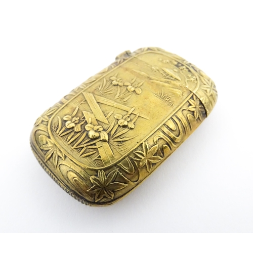 1173 - A 20thC brass vesta case with Oriental decoration. Approx. 1 3/4