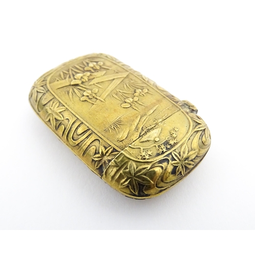 1173 - A 20thC brass vesta case with Oriental decoration. Approx. 1 3/4