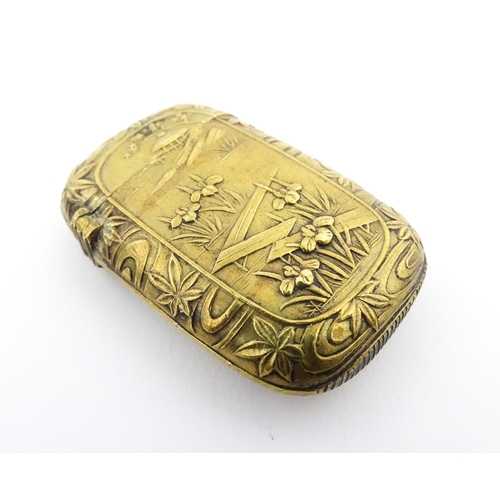 1173 - A 20thC brass vesta case with Oriental decoration. Approx. 1 3/4