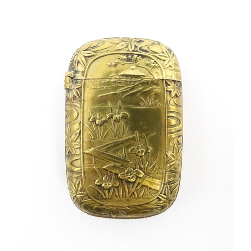 1173 - A 20thC brass vesta case with Oriental decoration. Approx. 1 3/4