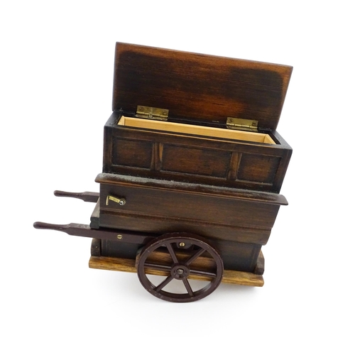 1174 - A 20thC novelty music box modelled as a street / barrow organ by Tallent of Bond Street. Numbered un... 