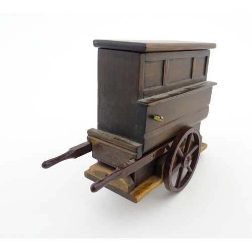 1174 - A 20thC novelty music box modelled as a street / barrow organ by Tallent of Bond Street. Numbered un... 