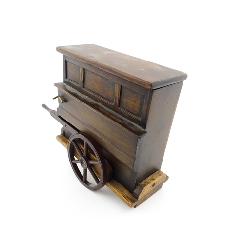 1174 - A 20thC novelty music box modelled as a street / barrow organ by Tallent of Bond Street. Numbered un... 