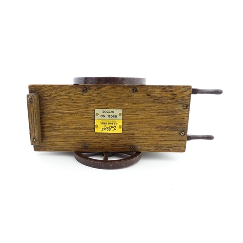 1174 - A 20thC novelty music box modelled as a street / barrow organ by Tallent of Bond Street. Numbered un... 