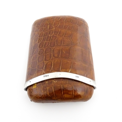 1176 - An early 20thC leather covered cigar case of shaped form, with silver mounts hallmarked London 1923,... 