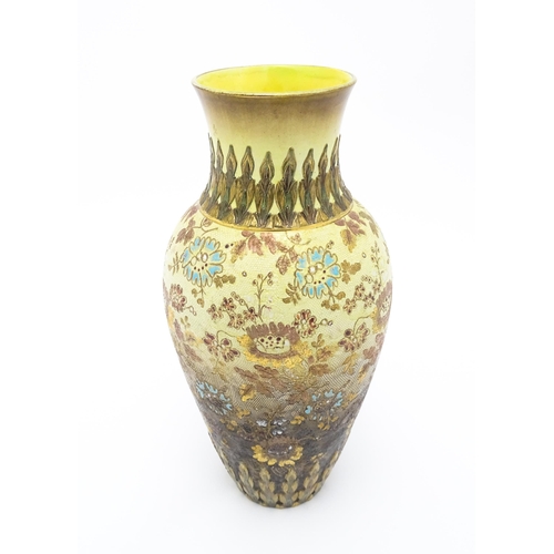 121 - A Doulton Lambeth vase of tapering form with floral and foliate decoration. Stamped under Doulton La... 