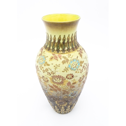 121 - A Doulton Lambeth vase of tapering form with floral and foliate decoration. Stamped under Doulton La... 