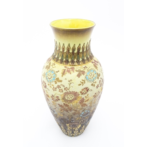 121 - A Doulton Lambeth vase of tapering form with floral and foliate decoration. Stamped under Doulton La... 