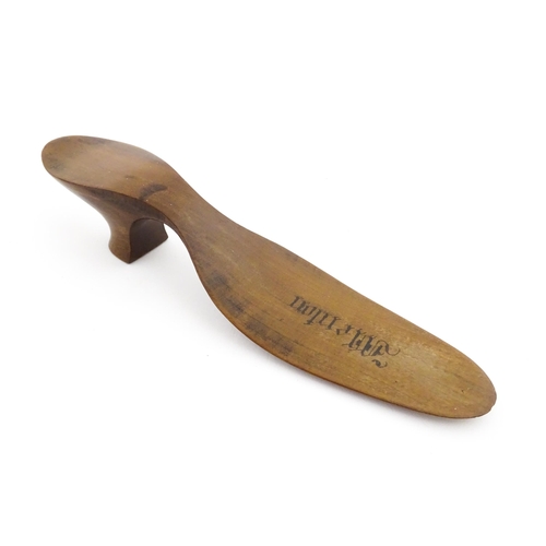 1210 - A 19thC French novelty treen souvenir shoehorn modelled as a ladies heeled shoe engraved Menton. App... 