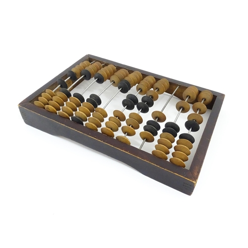 1231 - A Russian table top abacus. Bears remains of label with Cyrillic script. Approx. 9 1/2