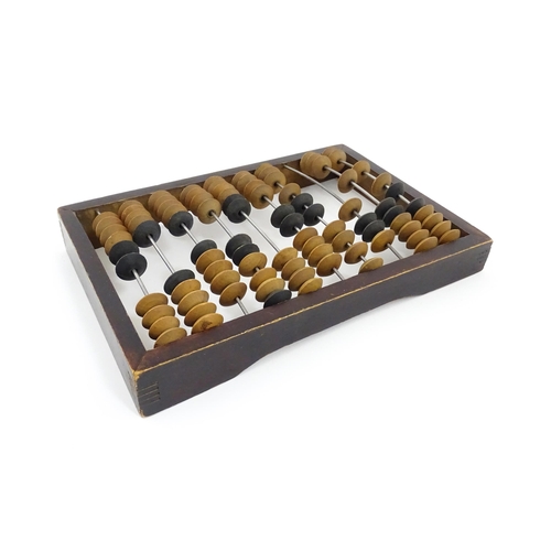 1231 - A Russian table top abacus. Bears remains of label with Cyrillic script. Approx. 9 1/2