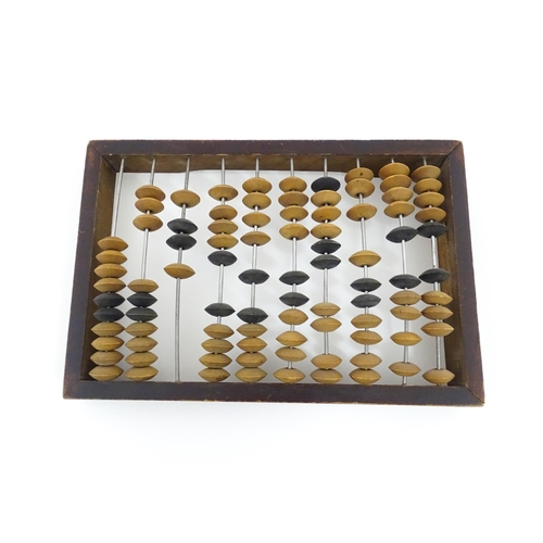 1231 - A Russian table top abacus. Bears remains of label with Cyrillic script. Approx. 9 1/2