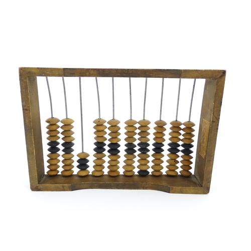 1231 - A Russian table top abacus. Bears remains of label with Cyrillic script. Approx. 9 1/2