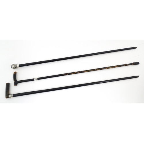 1247 - Three Victorian and later ebonised walking sticks / canes, one with an embossed silver top depicting... 