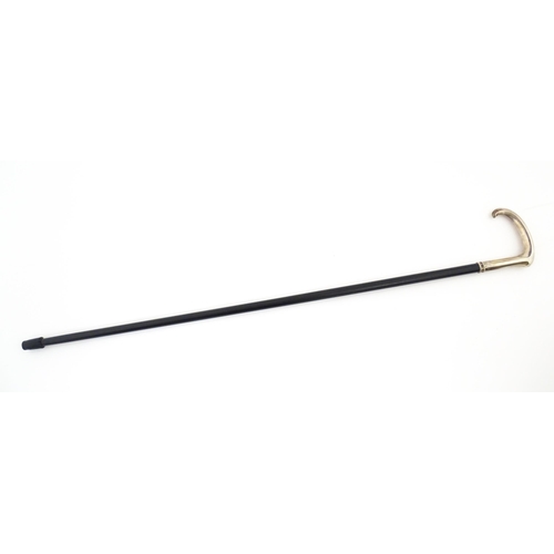 1252 - An ebonised walking stick / cane with Russian silver handle. Approx. 36