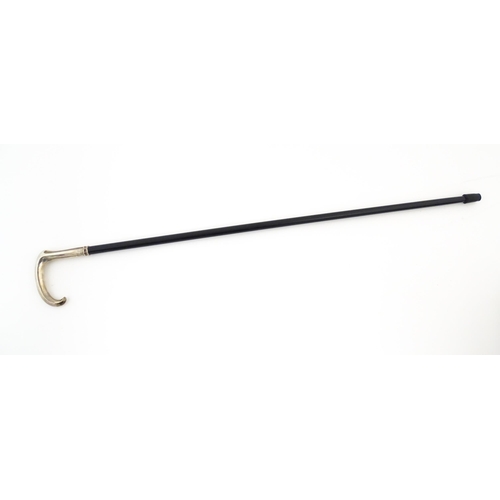 1252 - An ebonised walking stick / cane with Russian silver handle. Approx. 36