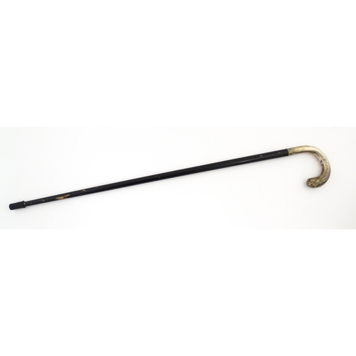 1253 - An ebonised walking stick / cane with Swedish .830 silver handle. Approx. 36 1/2