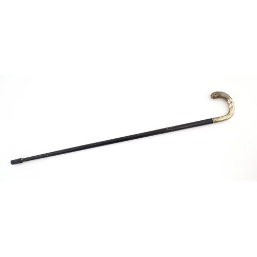 1253 - An ebonised walking stick / cane with Swedish .830 silver handle. Approx. 36 1/2