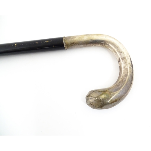 1253 - An ebonised walking stick / cane with Swedish .830 silver handle. Approx. 36 1/2