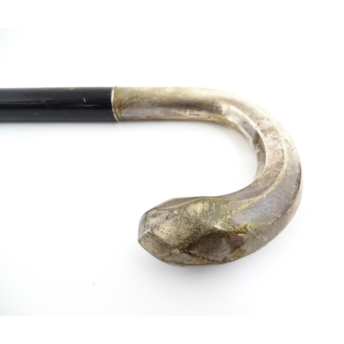 1253 - An ebonised walking stick / cane with Swedish .830 silver handle. Approx. 36 1/2