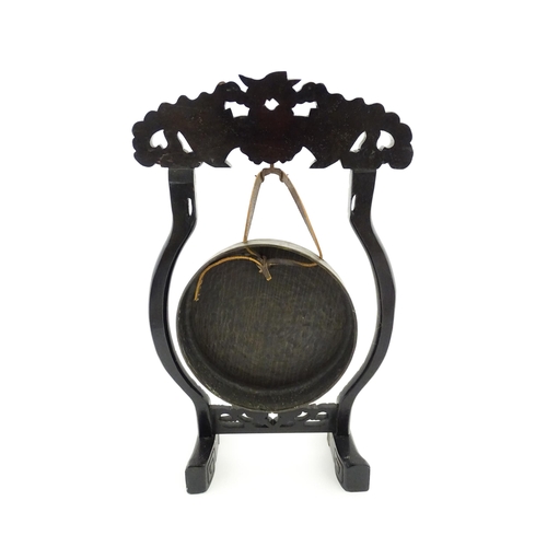 1274 - A 20thC Chinese gong and beater, the carved hardwood stand with central mask detail and scrolling st... 