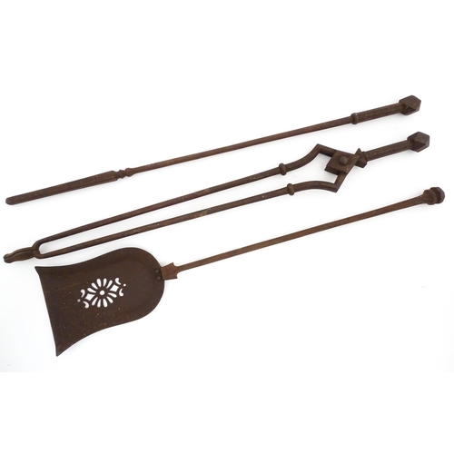 1276 - An early 20thC cast iron fireside companion set, /tools comprising shovel, tongs and poker. Each app... 