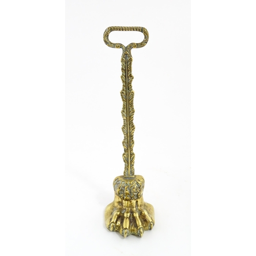 1279 - A Victorian cast brass door porter with lion paw detail. Approx. 14 1/2