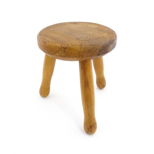 1285 - A 20thC fruitwood model of a milking stool. Approx. 6 1/4