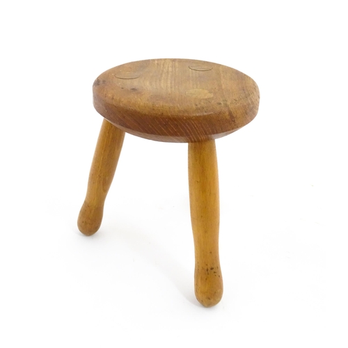 1285 - A 20thC fruitwood model of a milking stool. Approx. 6 1/4