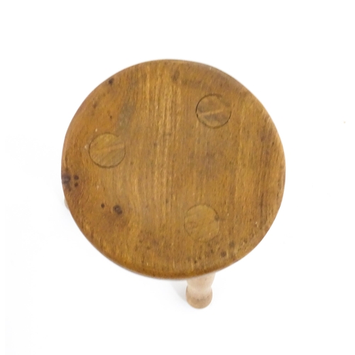 1285 - A 20thC fruitwood model of a milking stool. Approx. 6 1/4