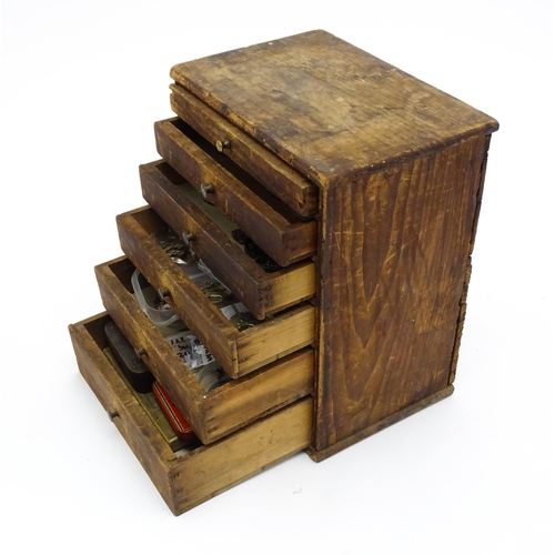1432 - A watchmakers / collectors small cabinet with six drawers containing various watch parts, movements,... 