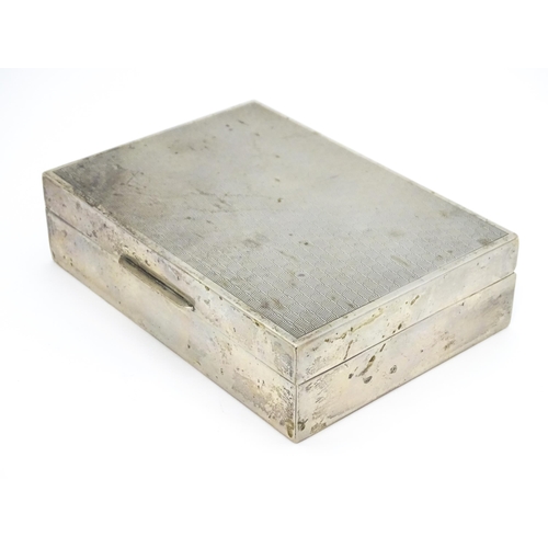 531 - A Continental .800 silver cigarette box with engine turned decoration and wood lined interior. Appro... 