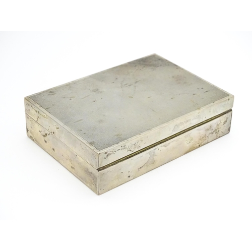 531 - A Continental .800 silver cigarette box with engine turned decoration and wood lined interior. Appro... 