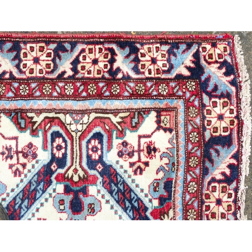 1517 - Carpet / Rug : A Persian Ardebil runner, the cream ground with floral and geometric repeating detail... 