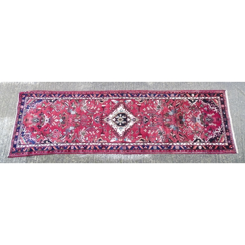 1518 - Carpet / Rug : A Persian Hamadan runner, the red ground with central cream ground medallion with flo... 