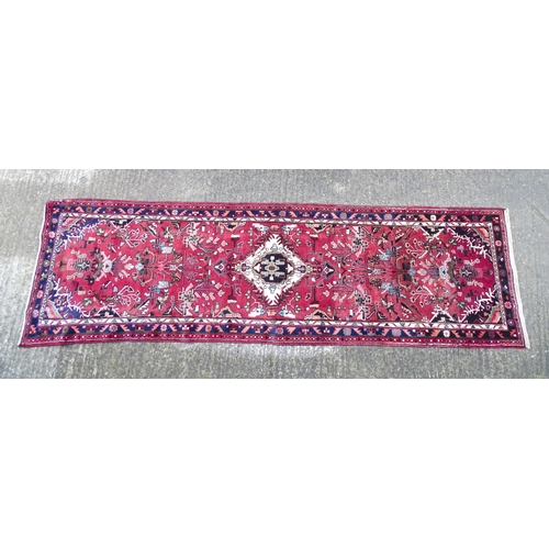 1518 - Carpet / Rug : A Persian Hamadan runner, the red ground with central cream ground medallion with flo... 