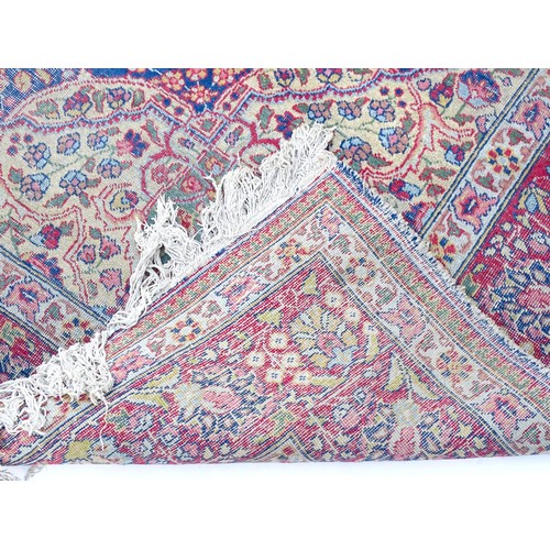 1502 - Carpet / Rug : A blue and cream ground rug profusely decorated with scrolling floral and foliate dec... 