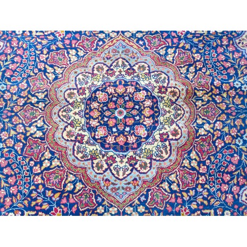 1502 - Carpet / Rug : A blue and cream ground rug profusely decorated with scrolling floral and foliate dec... 