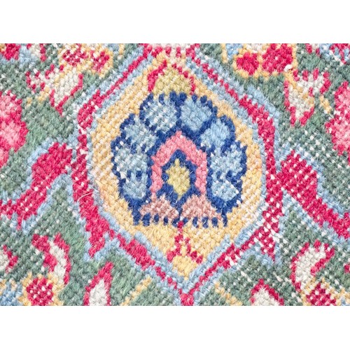 1502 - Carpet / Rug : A blue and cream ground rug profusely decorated with scrolling floral and foliate dec... 