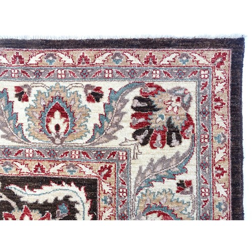 1506 - Carpet / Rug : A cream and black ground rug decorated with central medallion bordered by scrolling f... 