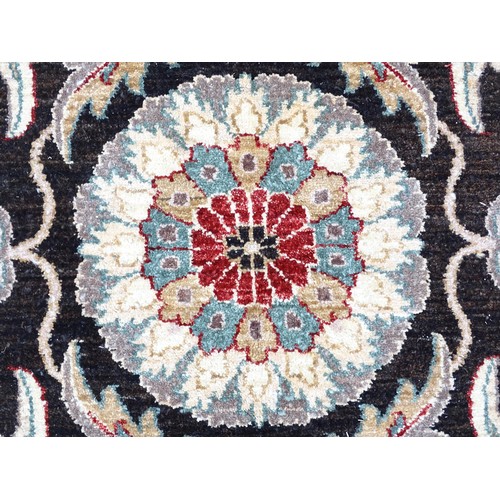 1506 - Carpet / Rug : A cream and black ground rug decorated with central medallion bordered by scrolling f... 