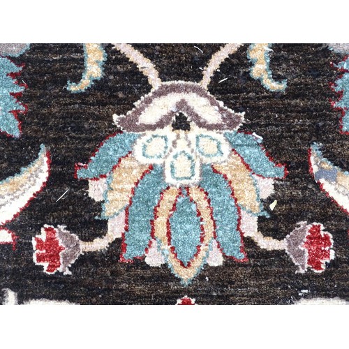 1506 - Carpet / Rug : A cream and black ground rug decorated with central medallion bordered by scrolling f... 