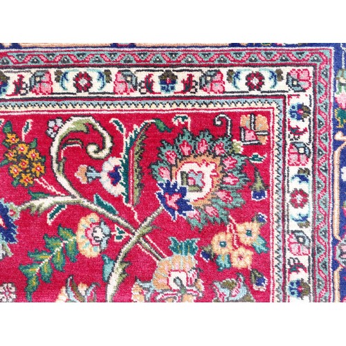 1521 - Carpet / Rug: A North West Persian Tabriz carpet the red ground with central cream and blue medallio... 